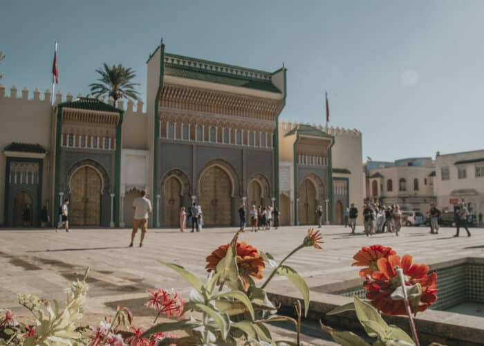 Royal Palace in Fes Morocco with tourists and flowers in the foreground
