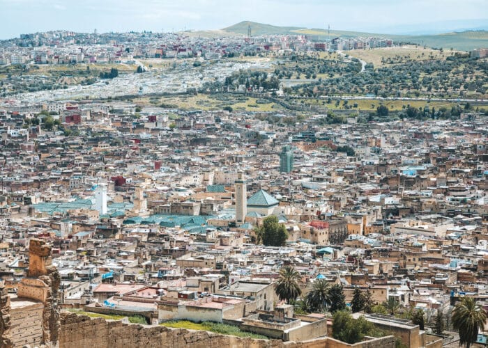 Panoramic view of Fes city with green-roofed mosques.