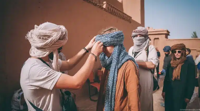 Tourists learning what to wear in Morocco by trying on traditional desert turbans